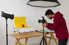Professional photographer in a studio setting, preparing for a shoot.