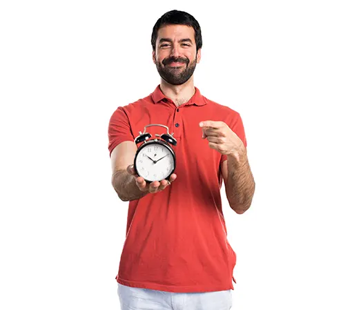 Young bearded man holding a table clock on his right extended hand pointing it with left hand finger front view