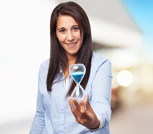 Young brunette woman in white shirt holding an hourglass in her left-hand front view