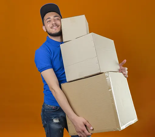 Young man in blue t-shirt and jeans carrying large boxes indicating ability to handle large orders