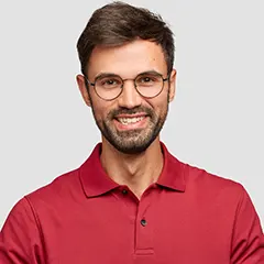 Young man with cherful expression gesture with something dressed red t-shirt Office worke