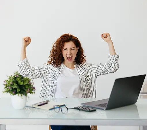 Photo editing service woman working with her laptop raising fist after