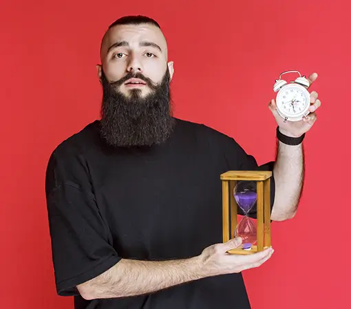 Young Hispanic man holding a sand clock and making an OK sign with his fingers, smiling in approval